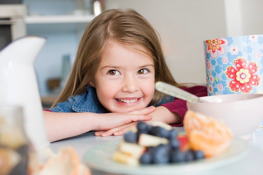 Girl smiling behind some health food