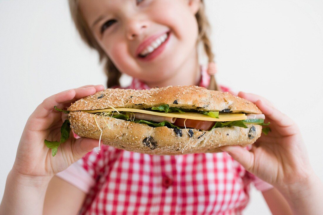 Girl holding sandwich