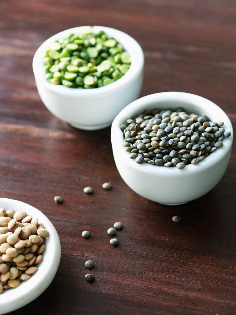 Various types of lentils in small dishes