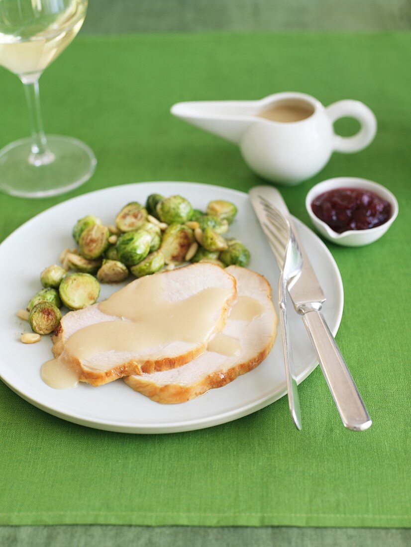 Slices of Thanksgiving Turkey with Gravy and Brussels Sprouts; Cranberry Sauce and White Wine