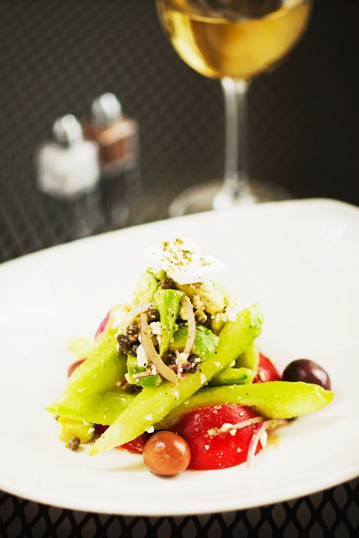 Greek Horiatiki Salad with a Glass of White Wine