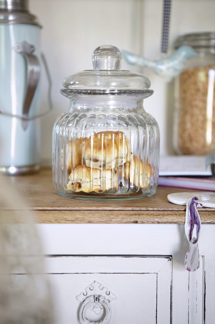 Scones in a storage jar in a kitchen