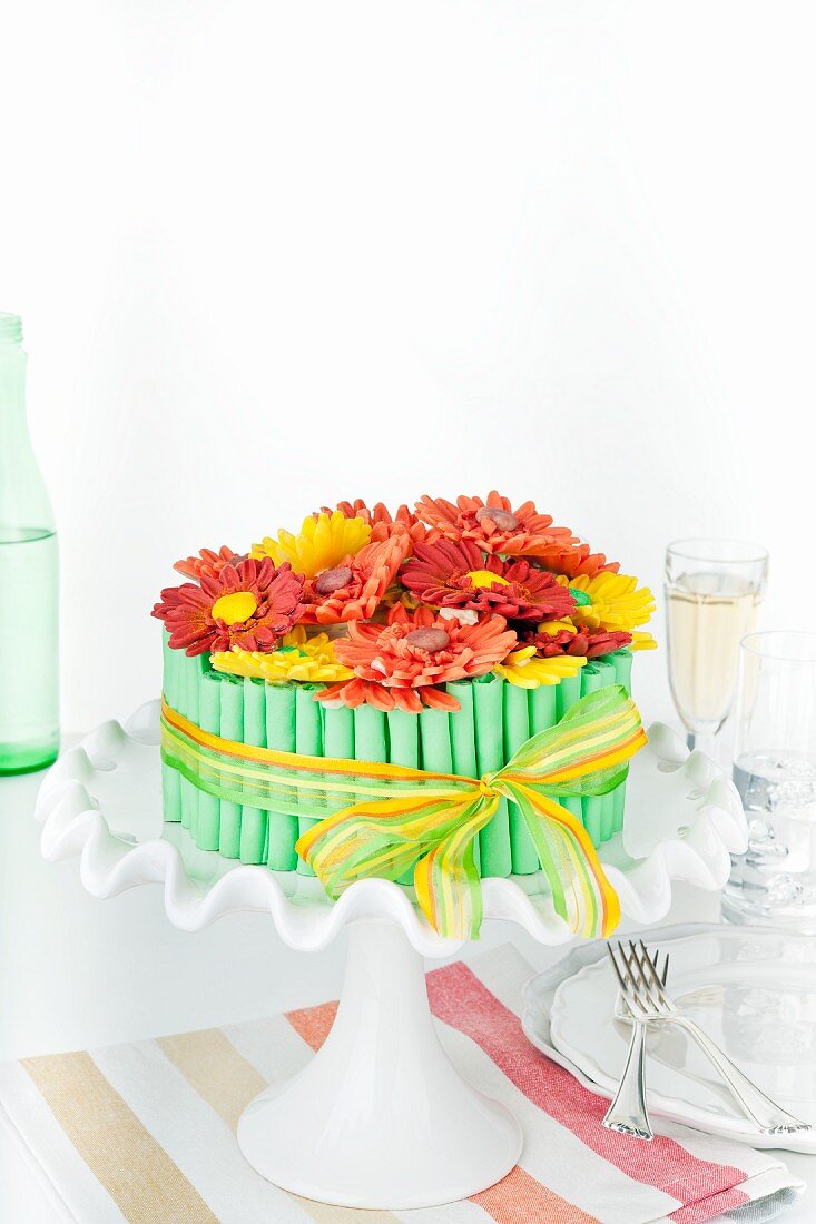 A birthday cake decorated with sugar gerberas