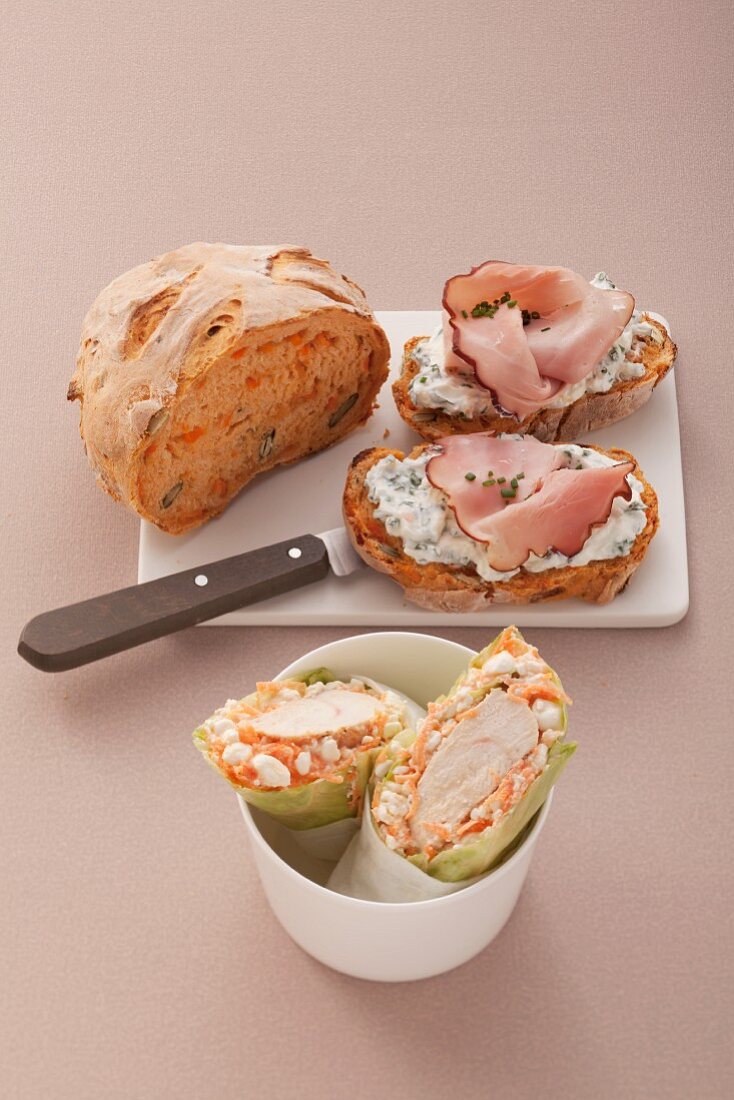 Carrot and pumpkin seed bread with herb quark and ham and salad wraps with chicken breast