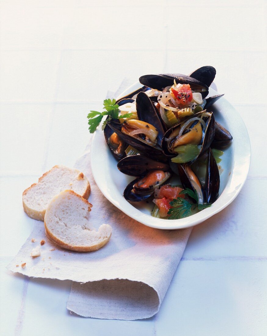 Mussels in a white wine reduction with celery, tomatoes and onions
