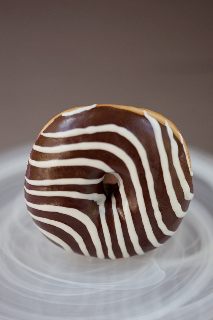 A black and white glazed doughnut