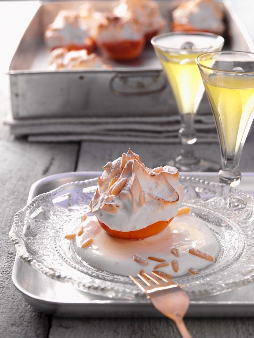 A baked apricot with meringue and slivered almonds