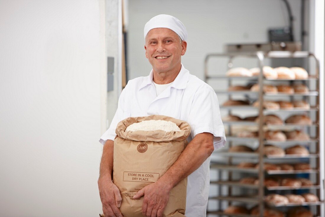A baker carrying a sack of flour