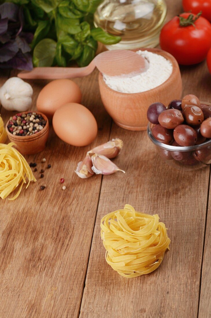 Tagliatelle, eggs, flour, olives, tomatoes and basil