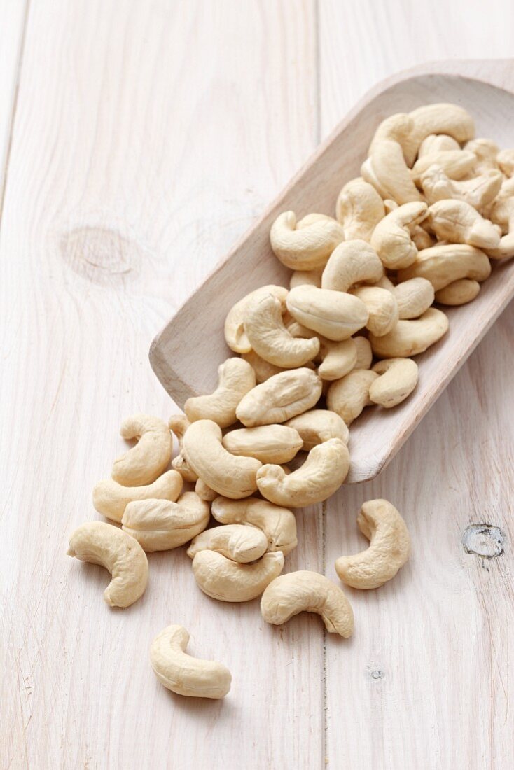 Cashew nuts on a wooden scoop