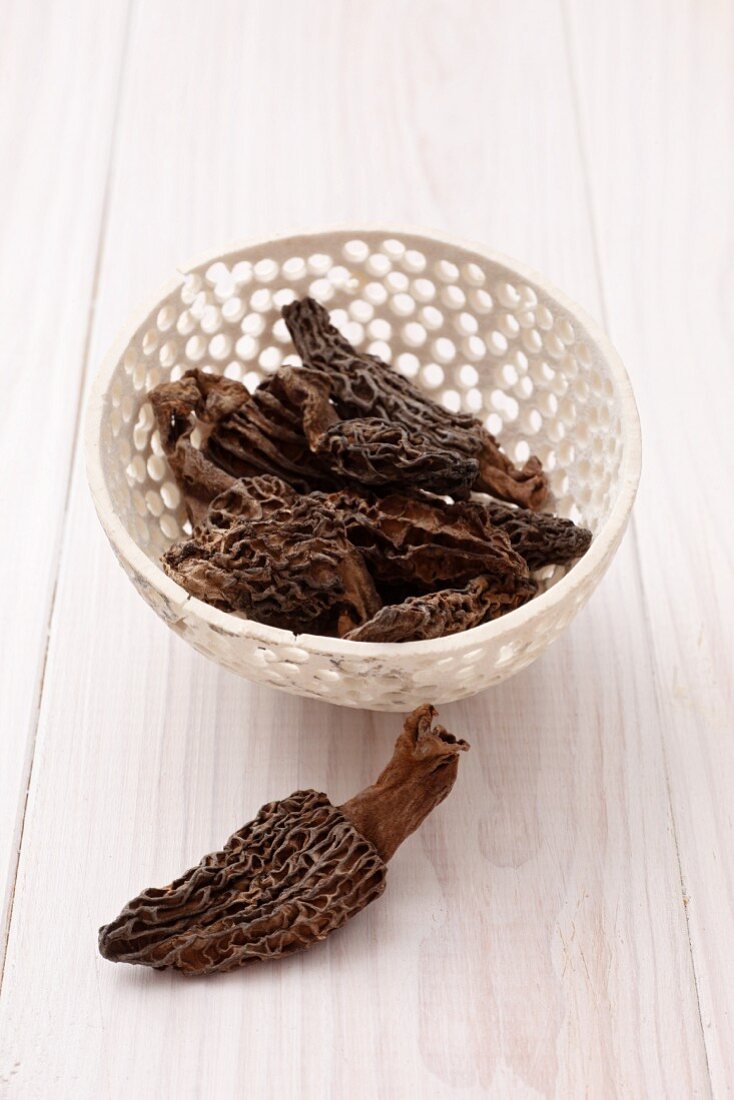 A bowl of dried pointed morel mushrooms