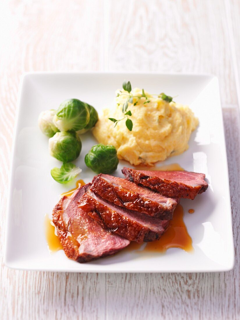 Duck breast with orange sauce, mashed potatoes and Brussels sprouts