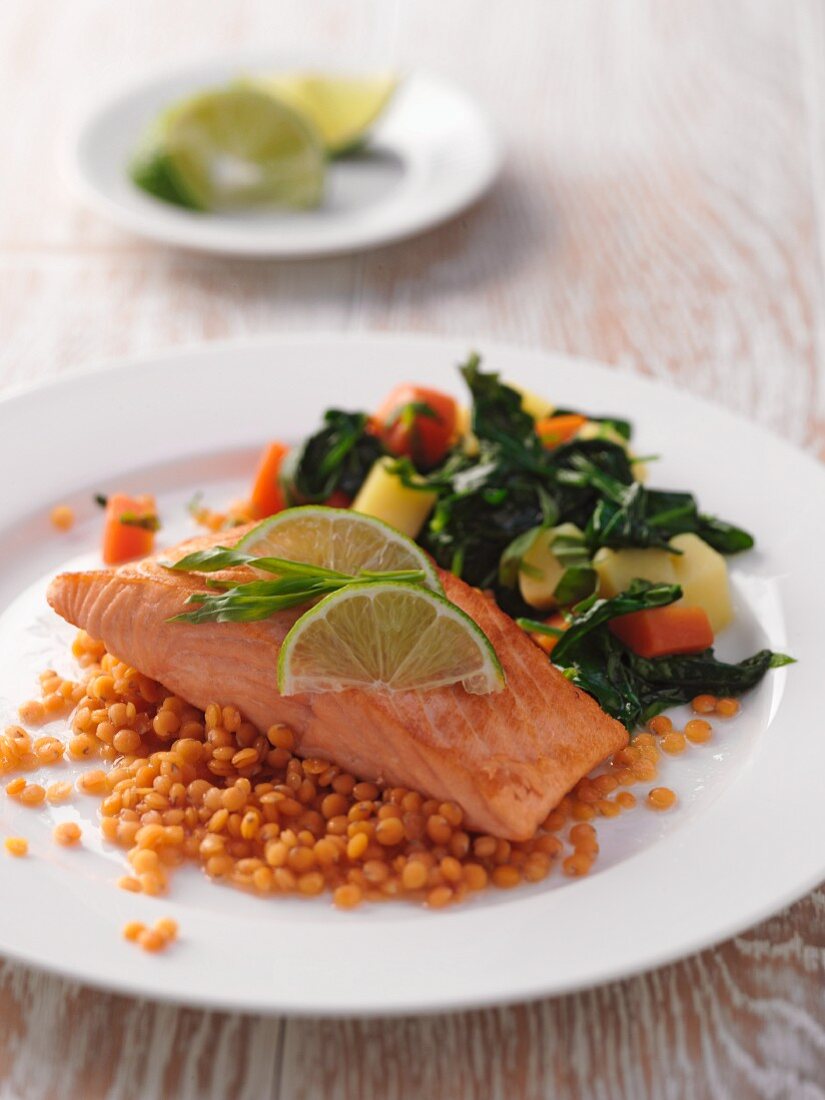 A fillet of salmon with red lentils and vegetables