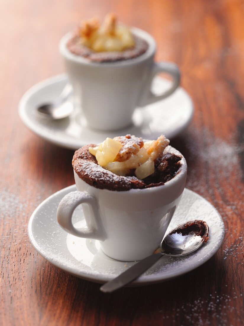 Chocolate puddings in cups with a pear and nut compote