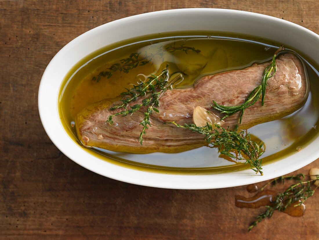 Pork fillet confit with oil and herbs