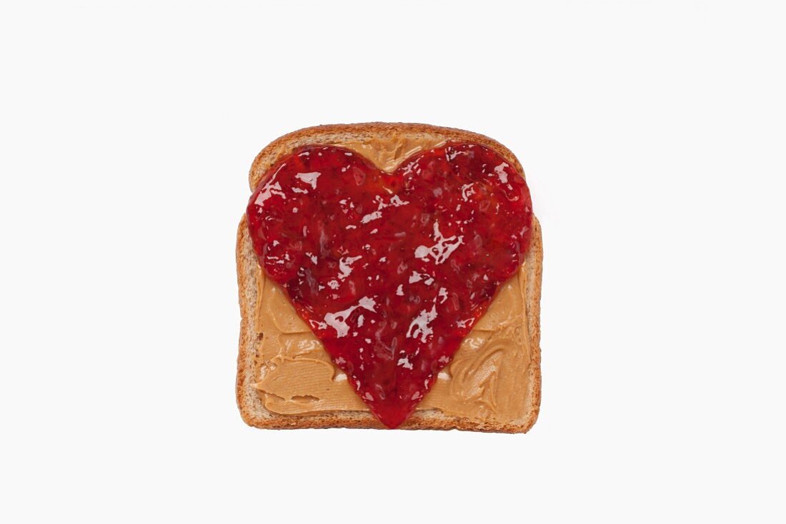 Slice of Bread with Peanut Butter and a Jelly Heart; White Background