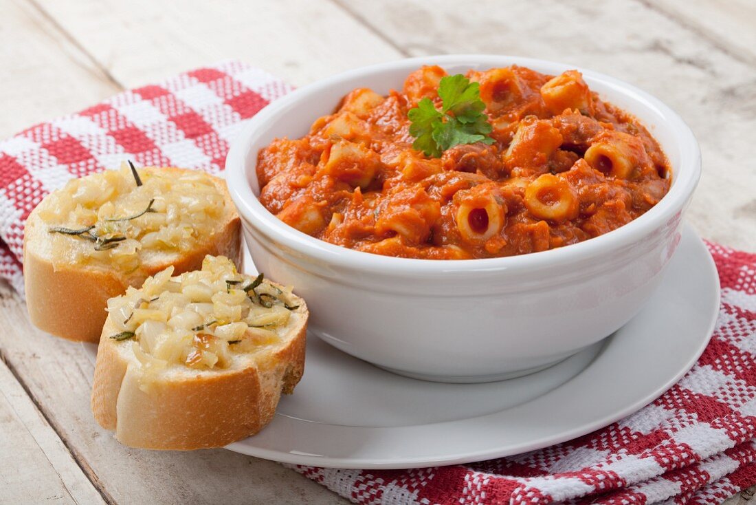 Pasta in a Tomato Meat Sauce with Slices of Garlic Bread
