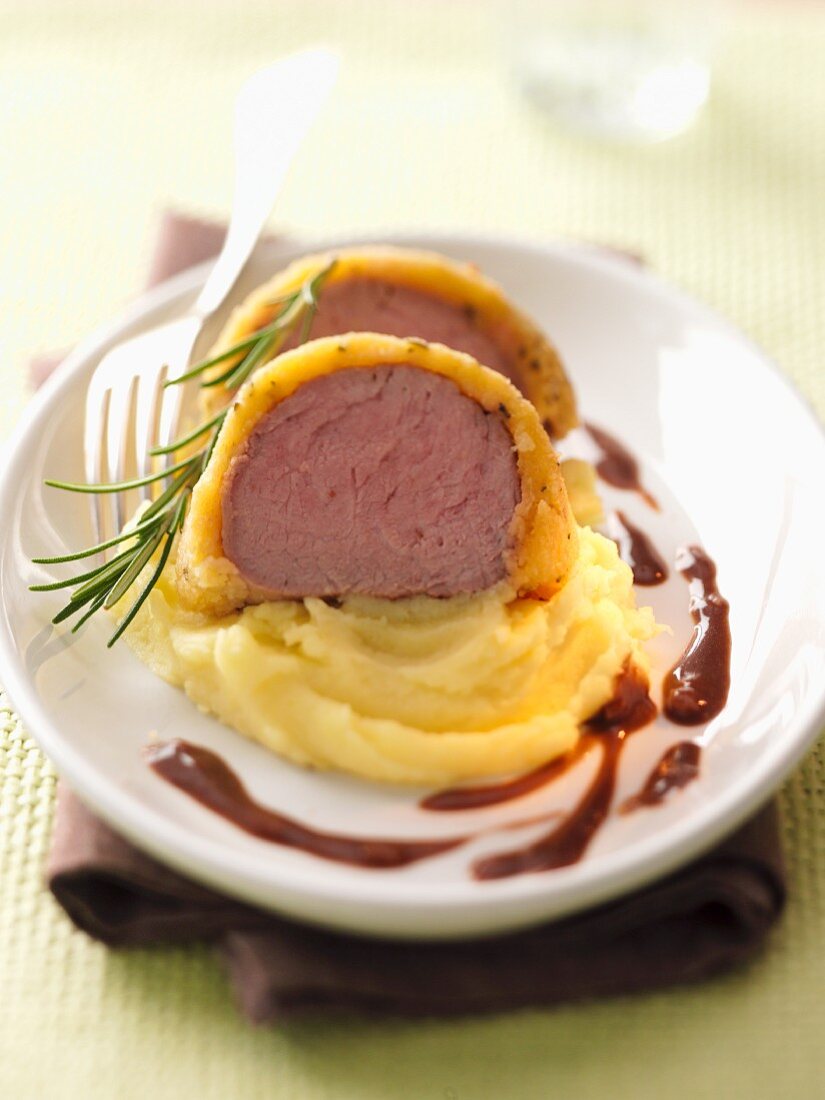 Veal fillet with a rosemary crust on a bed of mashed potatoes