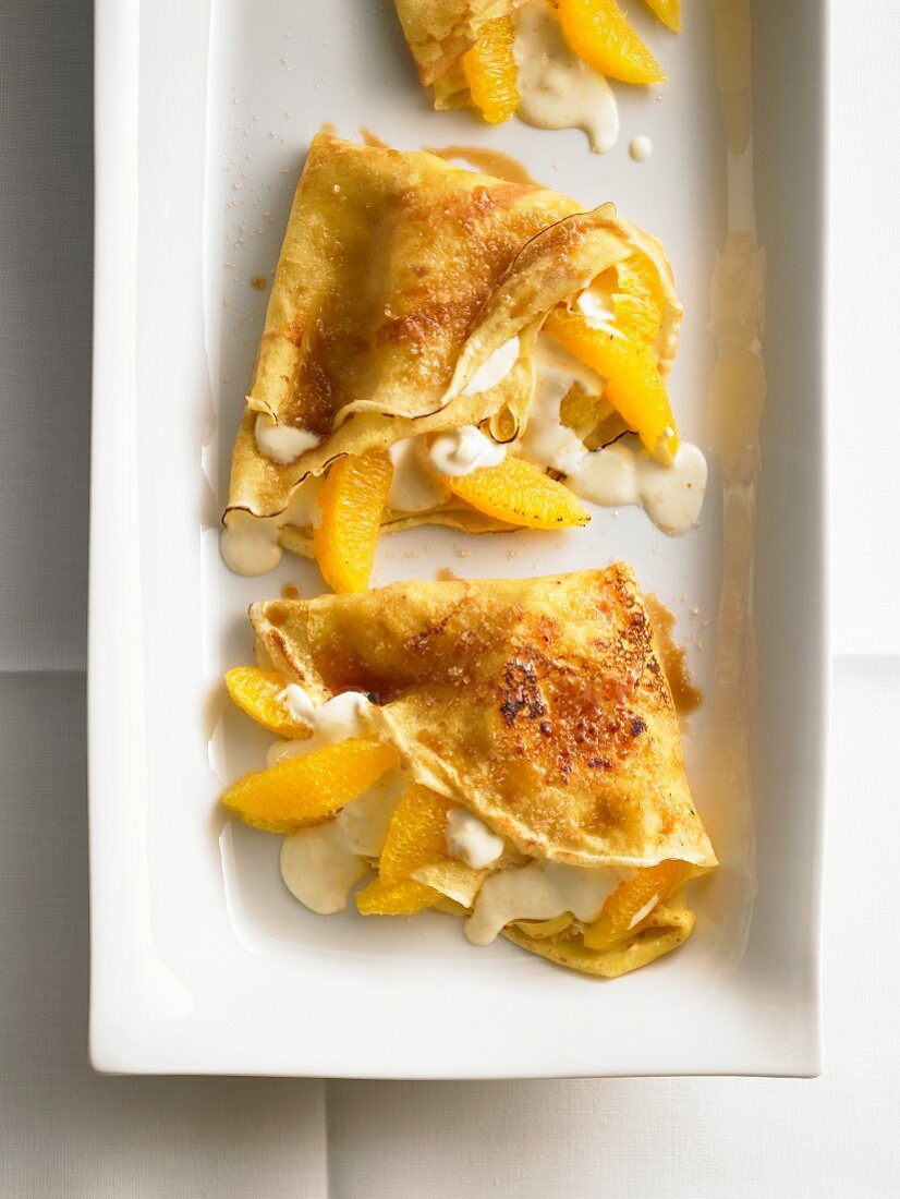 Orange crepes with vanilla sauce