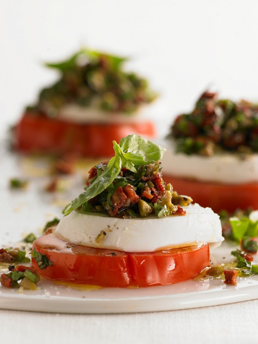 Tomato with mozzarella, bacon and basil