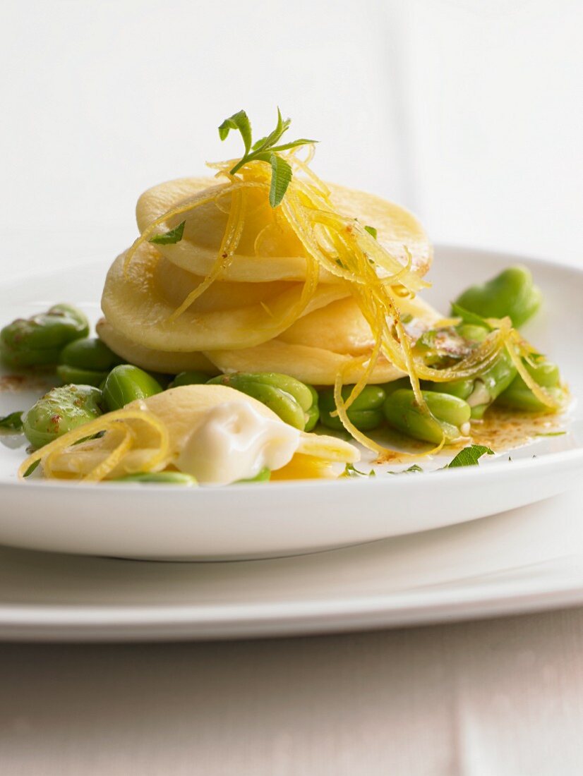 Ravioli filled with pecorino cheese on broad beans