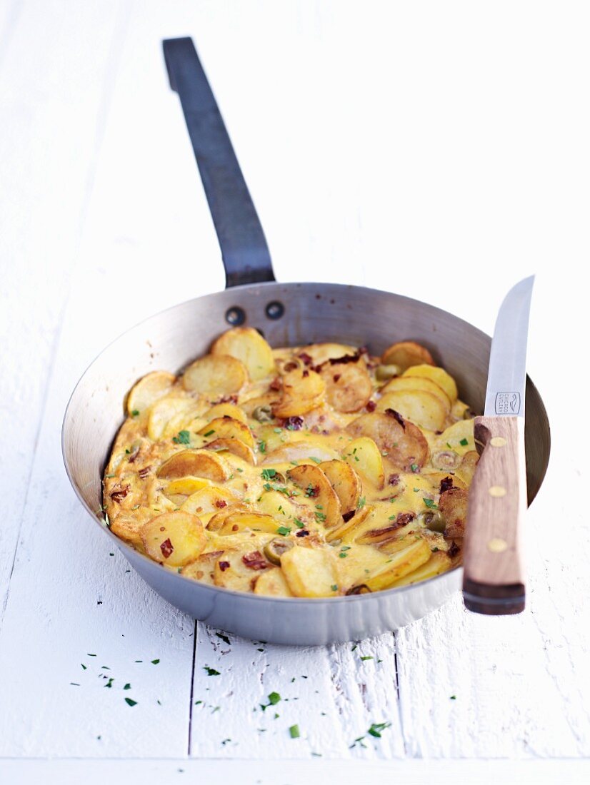 Potato tortilla in frying pan