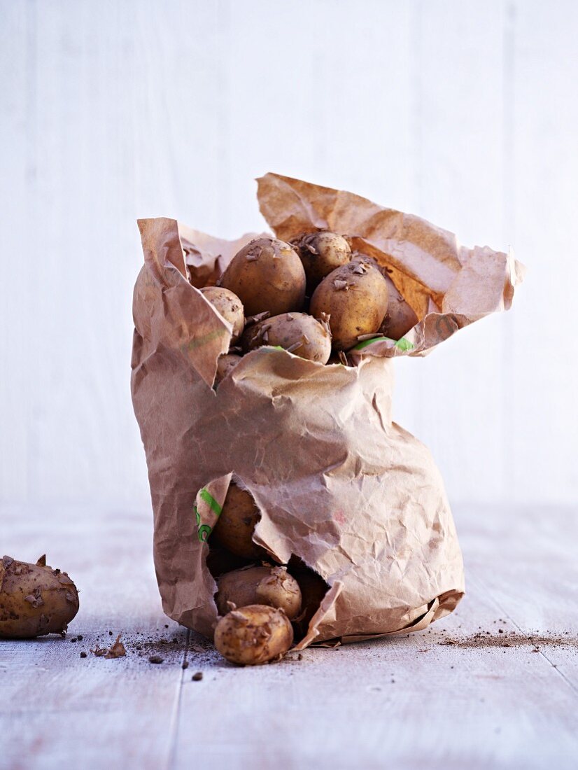 New potatoes in a torn paper sack