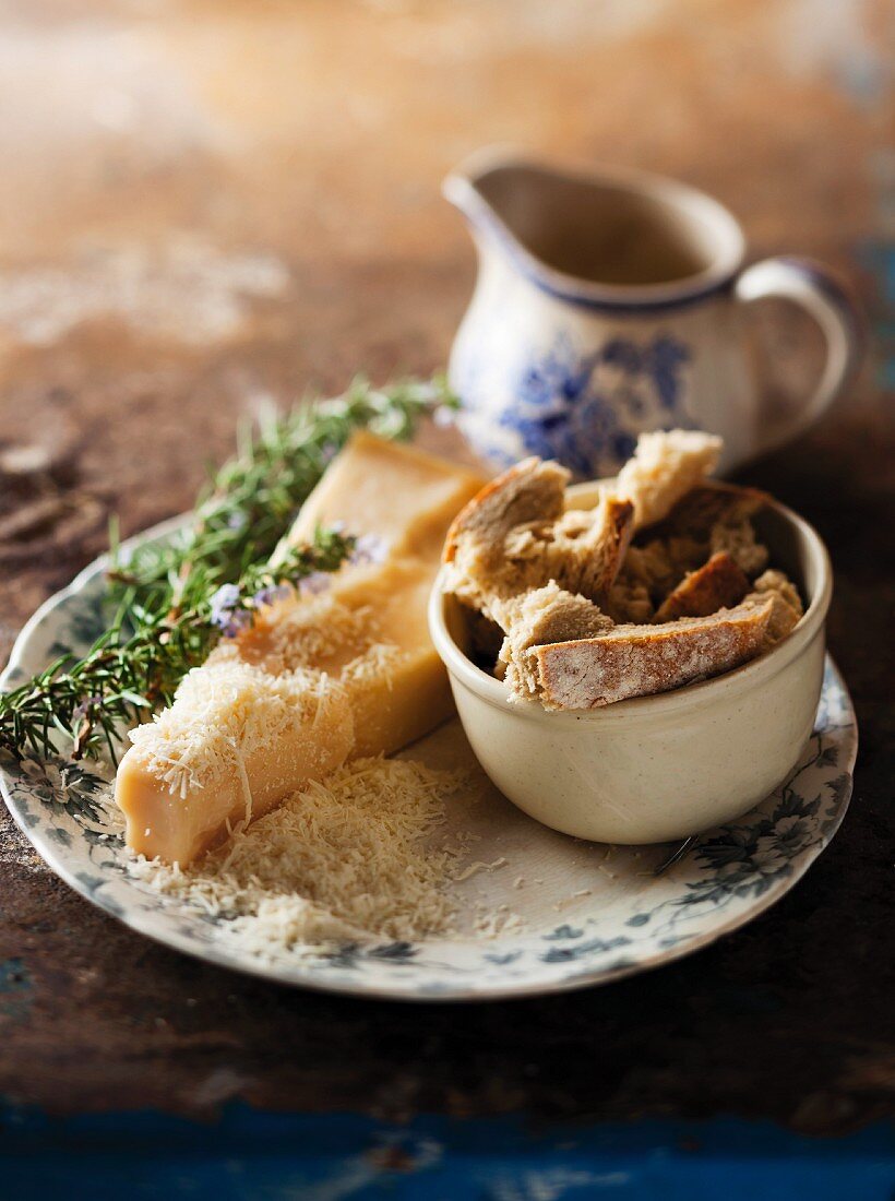 Ingredient still life featuring bread, parmesan cheese and rosemary