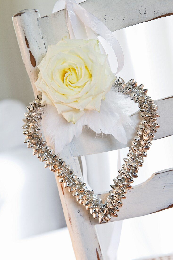 White rose and silver heart on back of chair