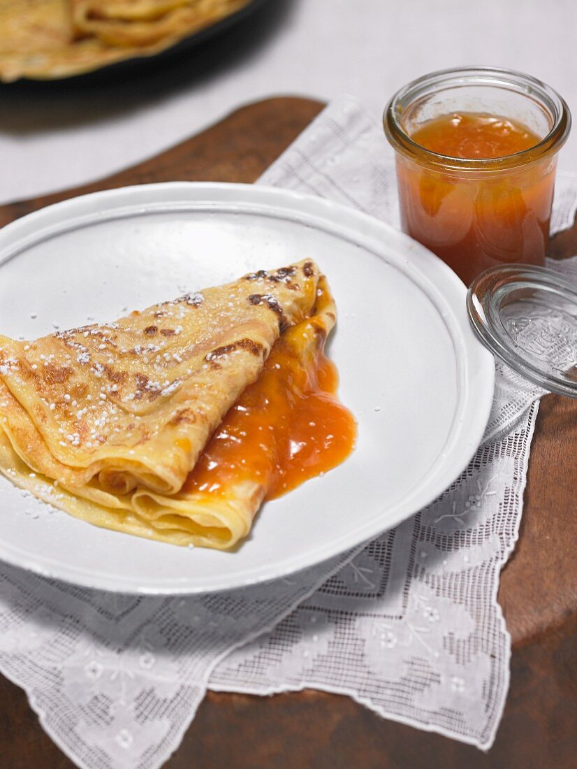 A pancake with fresh apricot jam