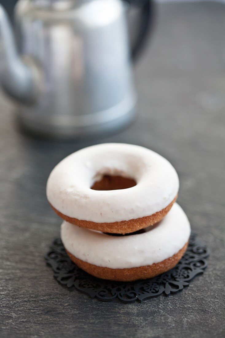 Two doughnuts with icing sugar