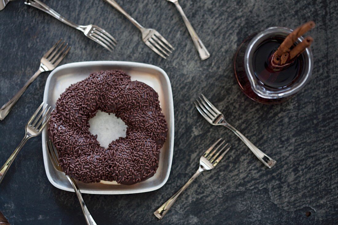 A giant doughnut with chocolate glaze and chocolate sprinkles