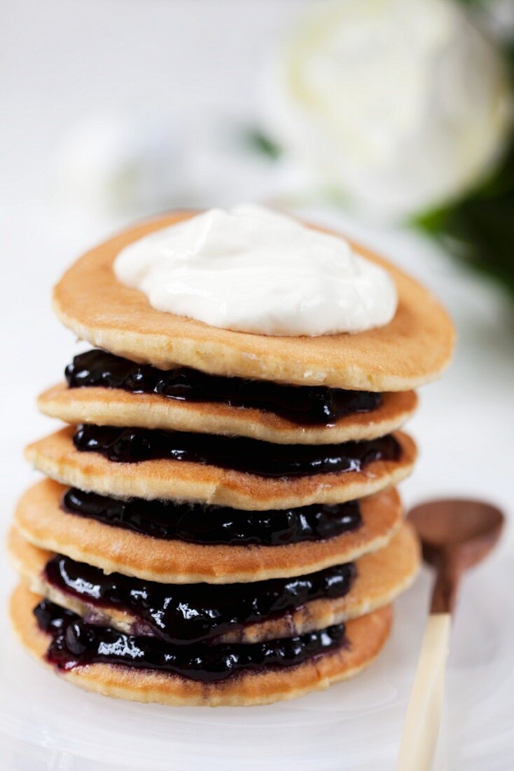 A stack of pancakes with blueberry jam