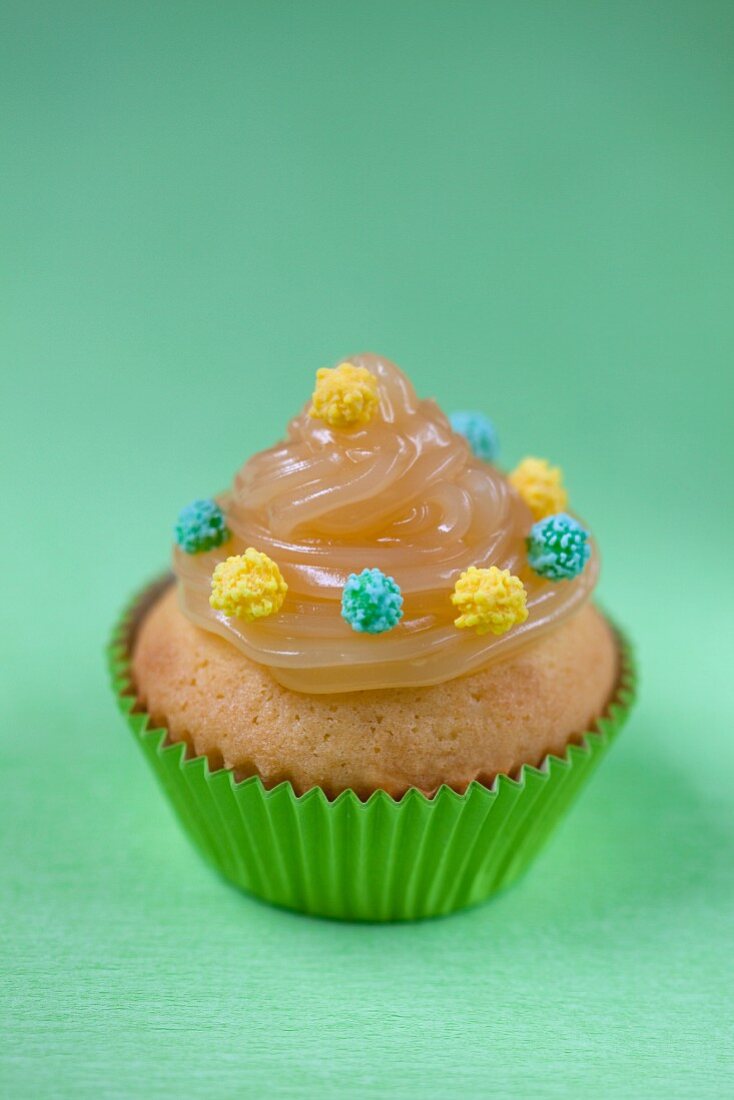 Ein Cupcake mit Lemon Curd und Zuckerperlen
