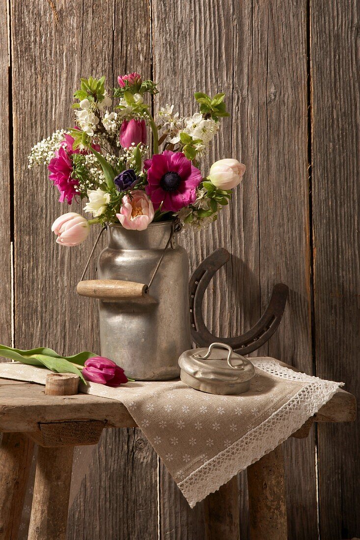 Spring bouquet in an old milk canister