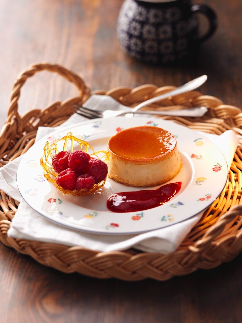 Crème caramel with a caramel basket and raspberries