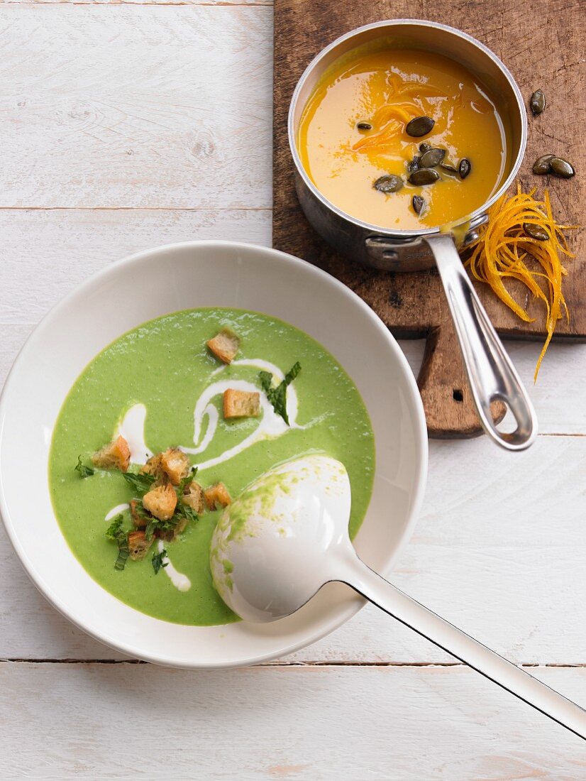 Pea and mint soup with pumpkin and orange soup