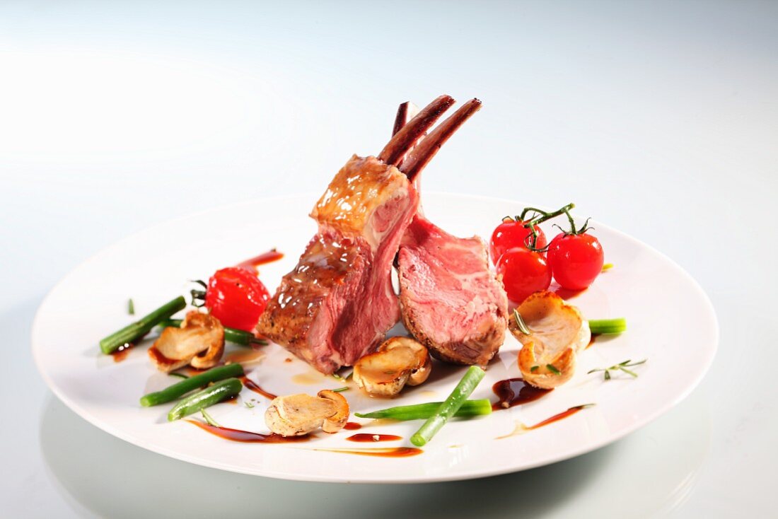 Lamb crown with mushrooms, beans and cherry tomatoes
