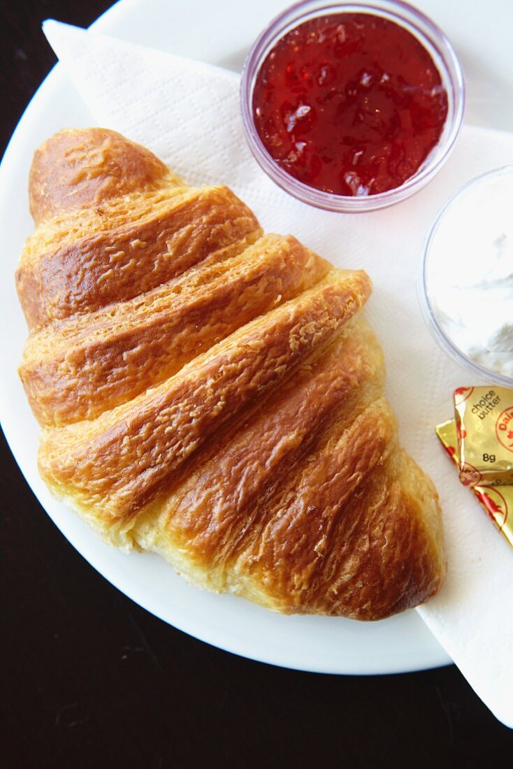 A croissant, jam and butter