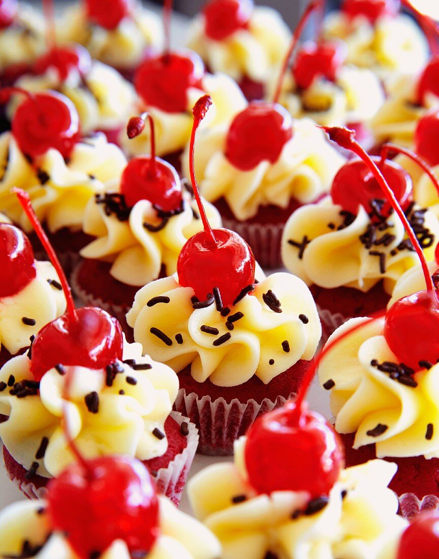 Mini red velvet cakes decorated with cocktail cherries