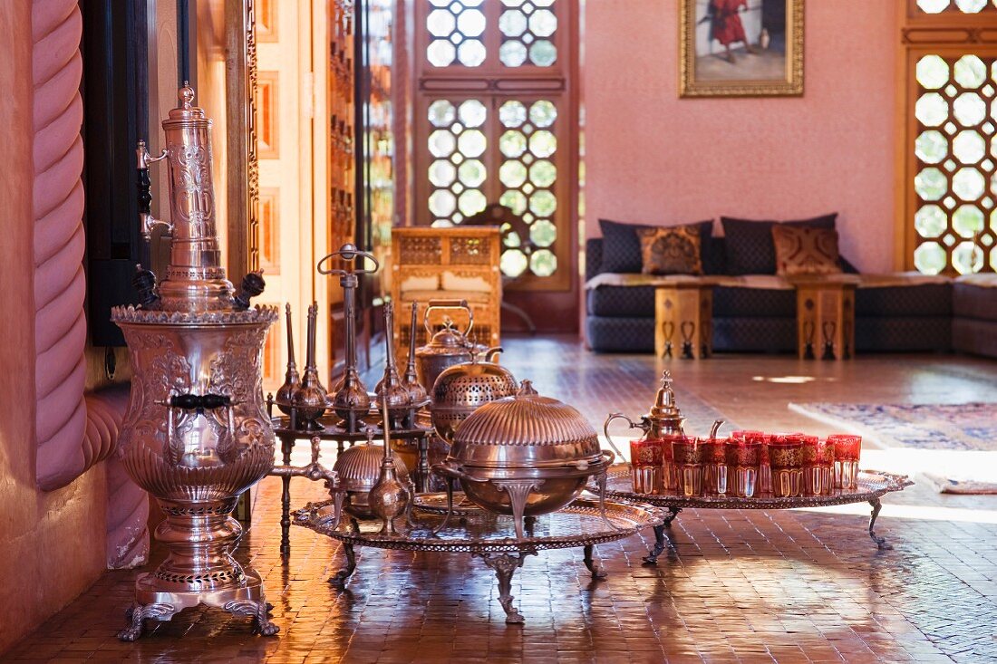 Antique silver tea set and floor trays in a salon marocain