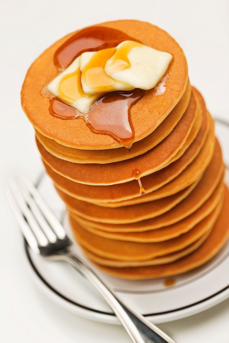 Tall Stack of Pancakes with Butter and Maple Syrup