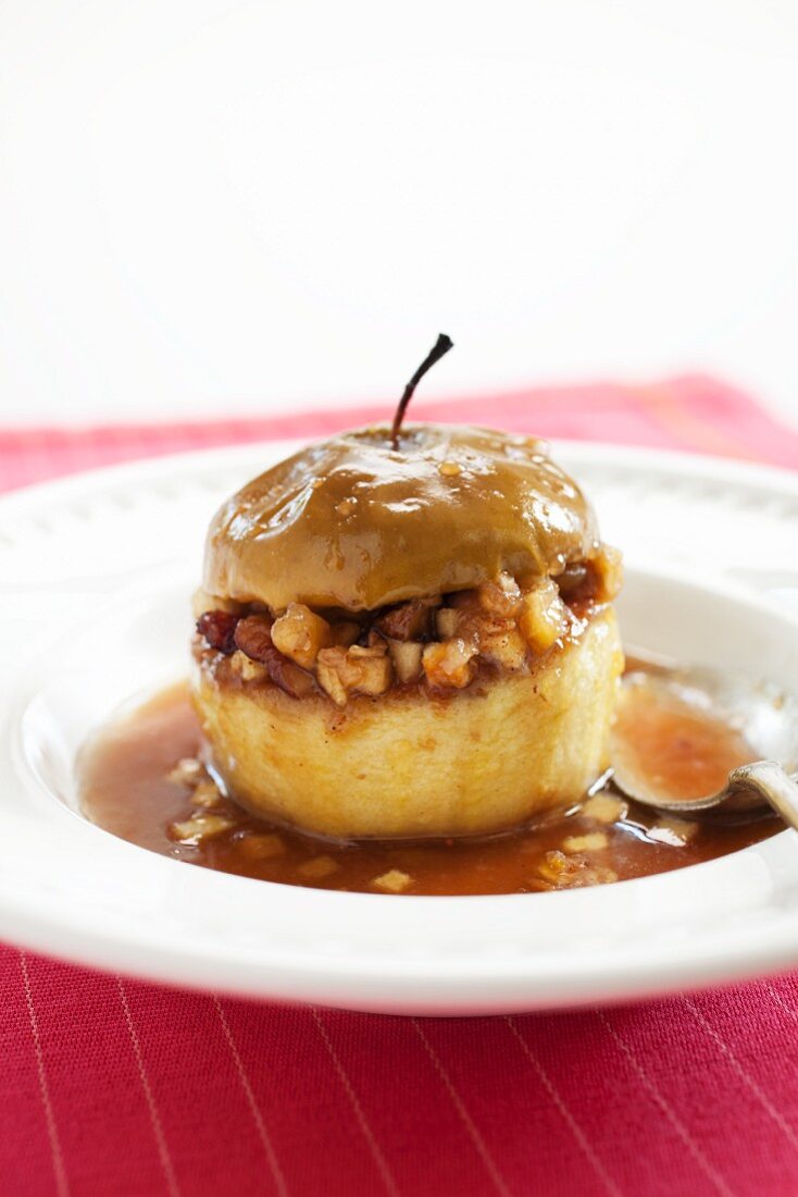 Stuffed Baked Apple in a Shallow Bowl; Spoon