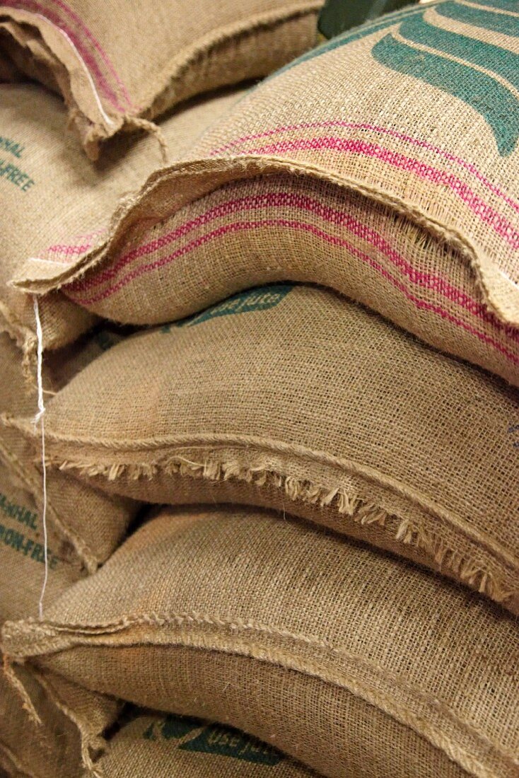 A stack of jute sacks with coffee beans