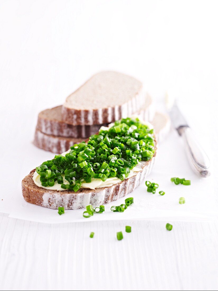 Bread and butter on plate with chives