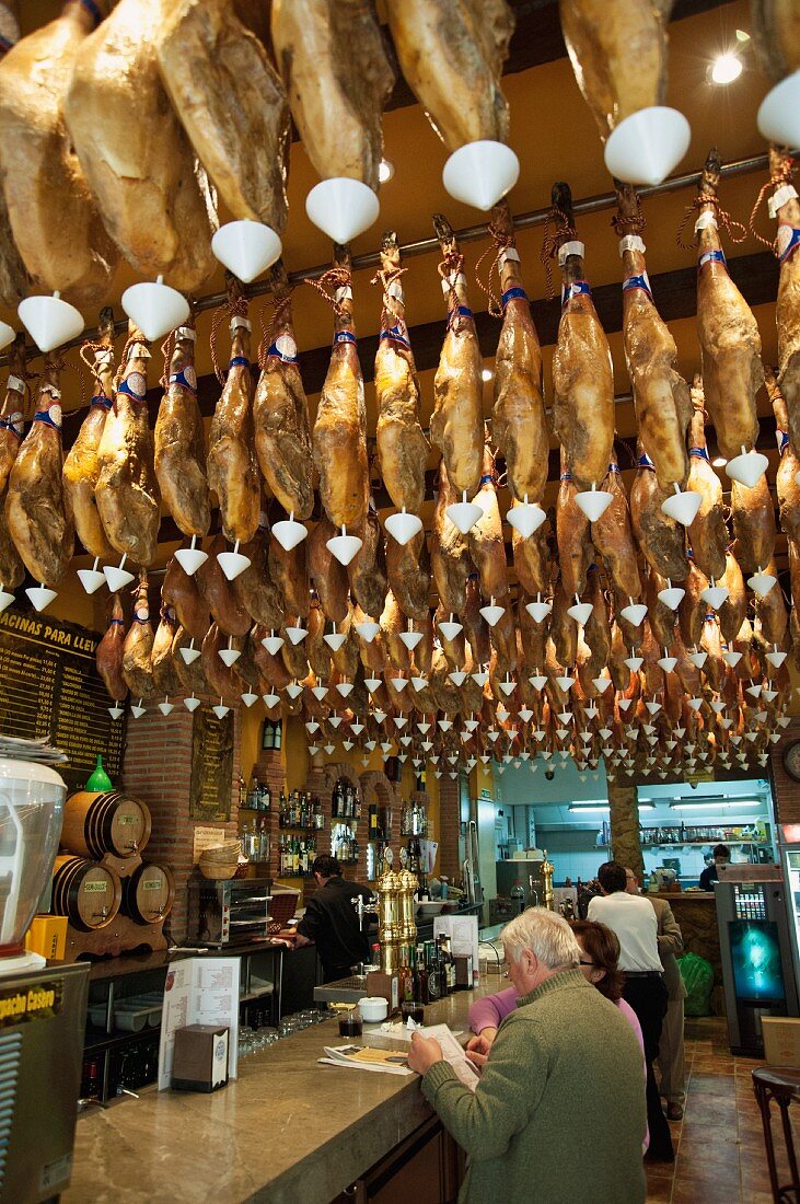 Legs of ham hanging in a tapas bar