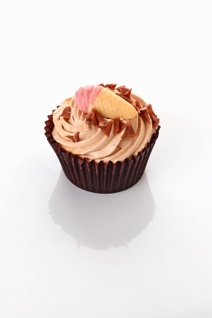 A cupcake decorated with an ice cream cone