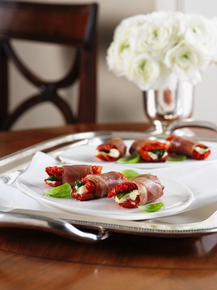 Prosciutto rolls with dried tomatoes and goat's cheese for Christmas