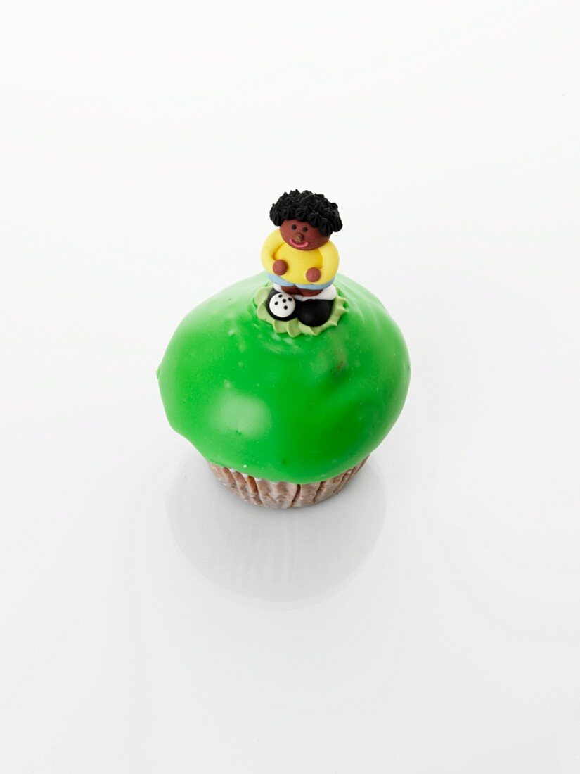 A cupcake decorated with a sugar figure