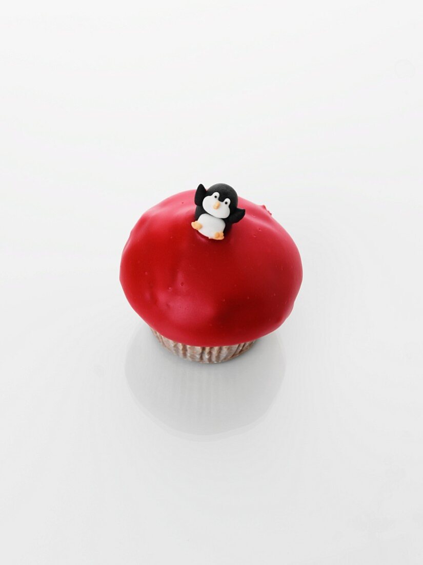 A cupcake decorated with a penguin